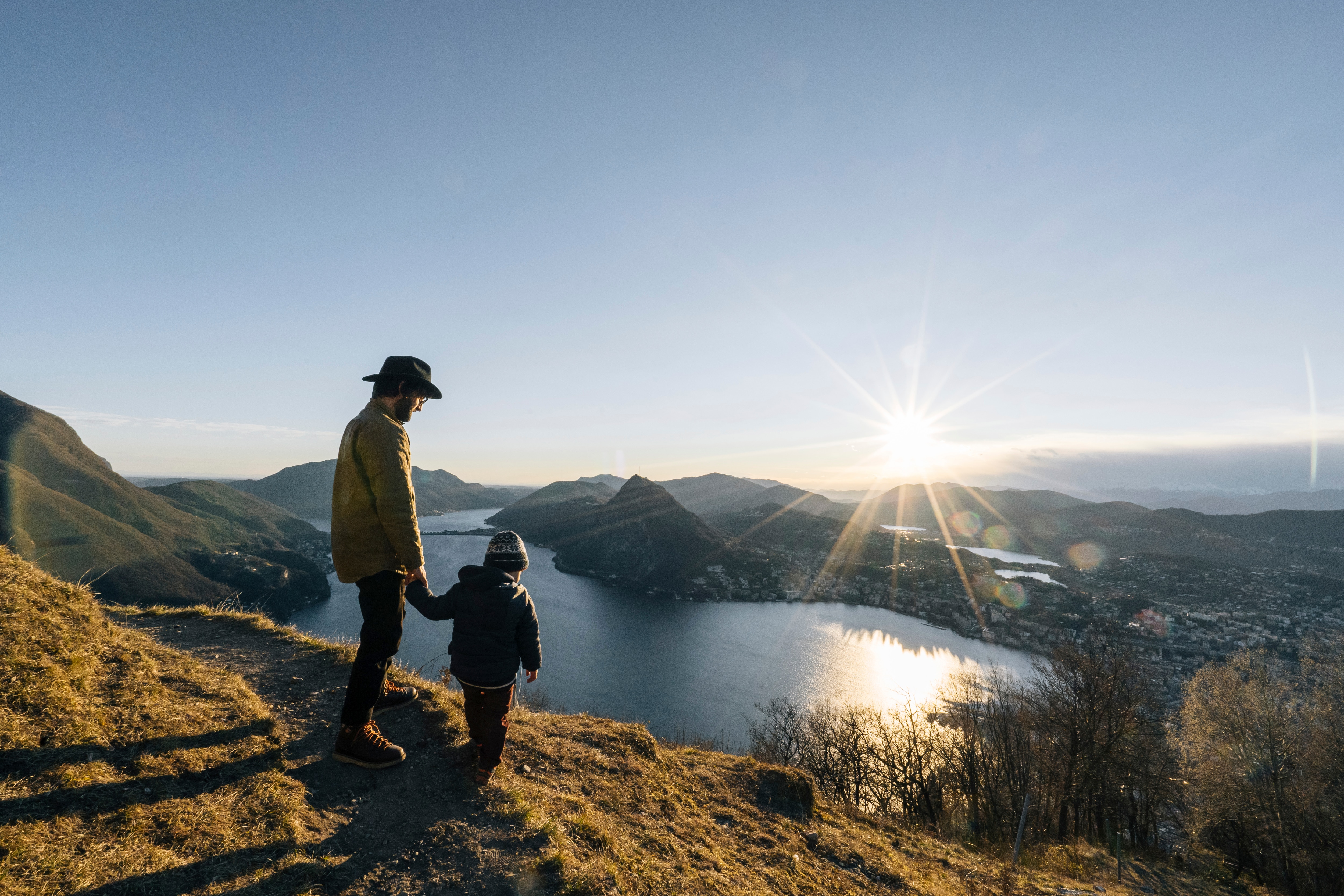 Father with son standing on a montain in Ticino Bello