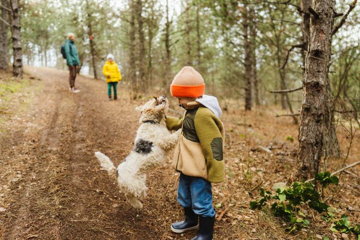 Jeune garçon passant du temps dans la nature avec son frère, son père et leur animal de compagnie