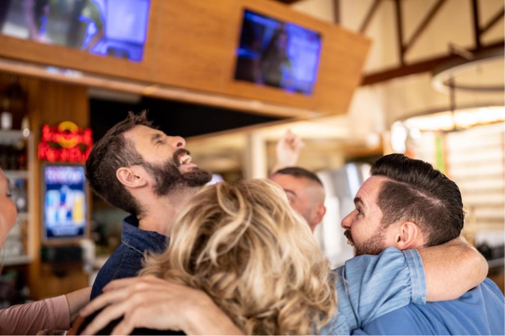 Freunde jubeln in einer Bar 
