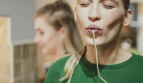 Eine Frau schlürft Spaghetti mit Genuss