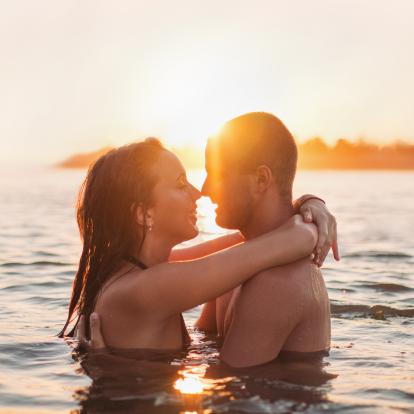 young couple in the water being close