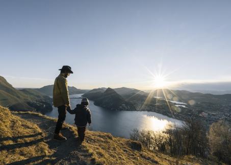 Father with son standing on a montain in Ticino Bello