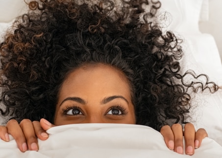 Frau kuschelt im Bett