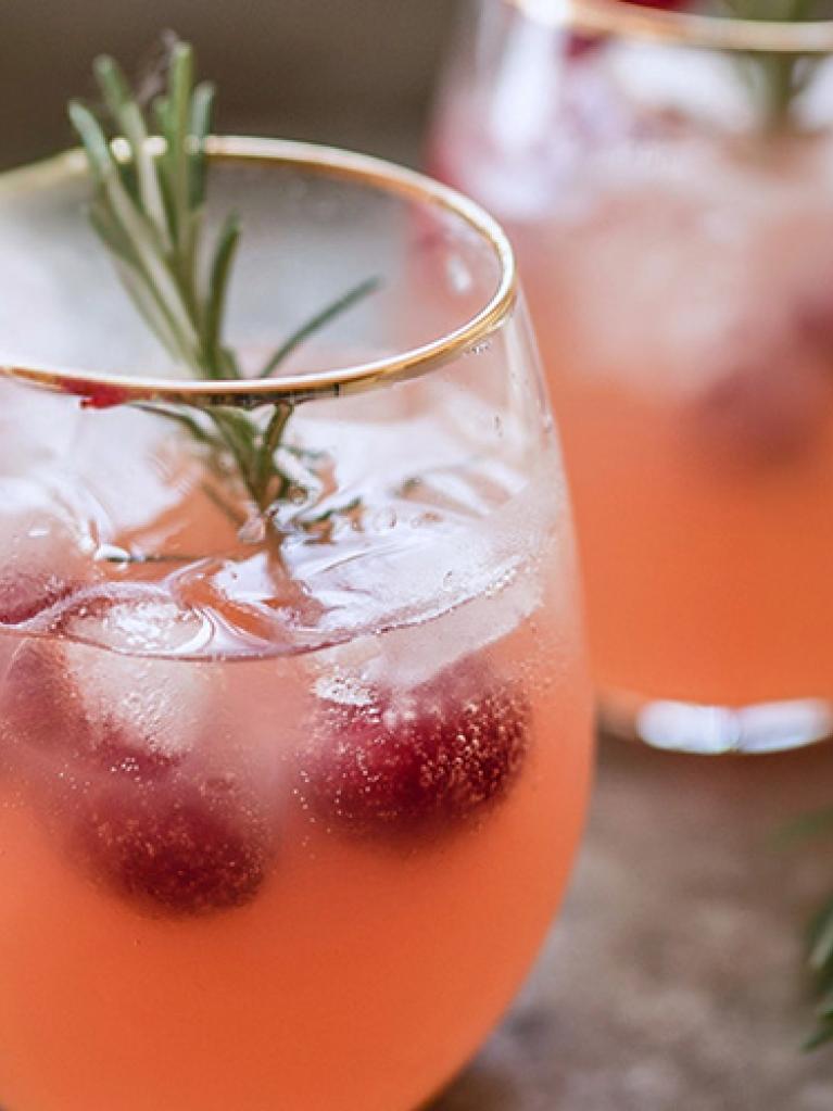 Spritz rosé sans alcool aux agrumes, cranberry et rondelle de citron, glaçons et romarin